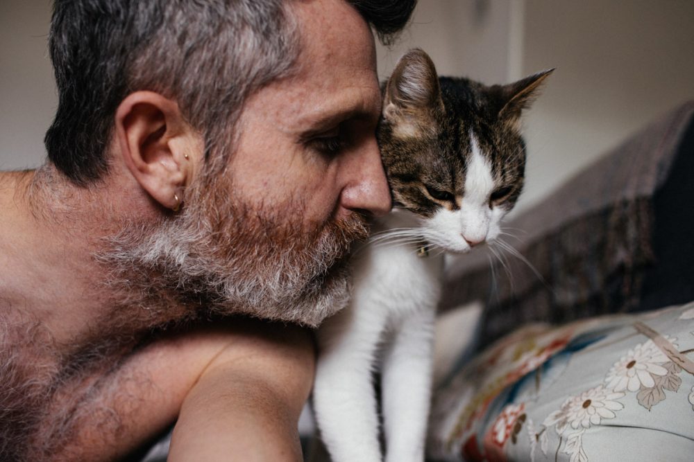 mike cuddling his cat rufus